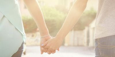 women_hold_hands